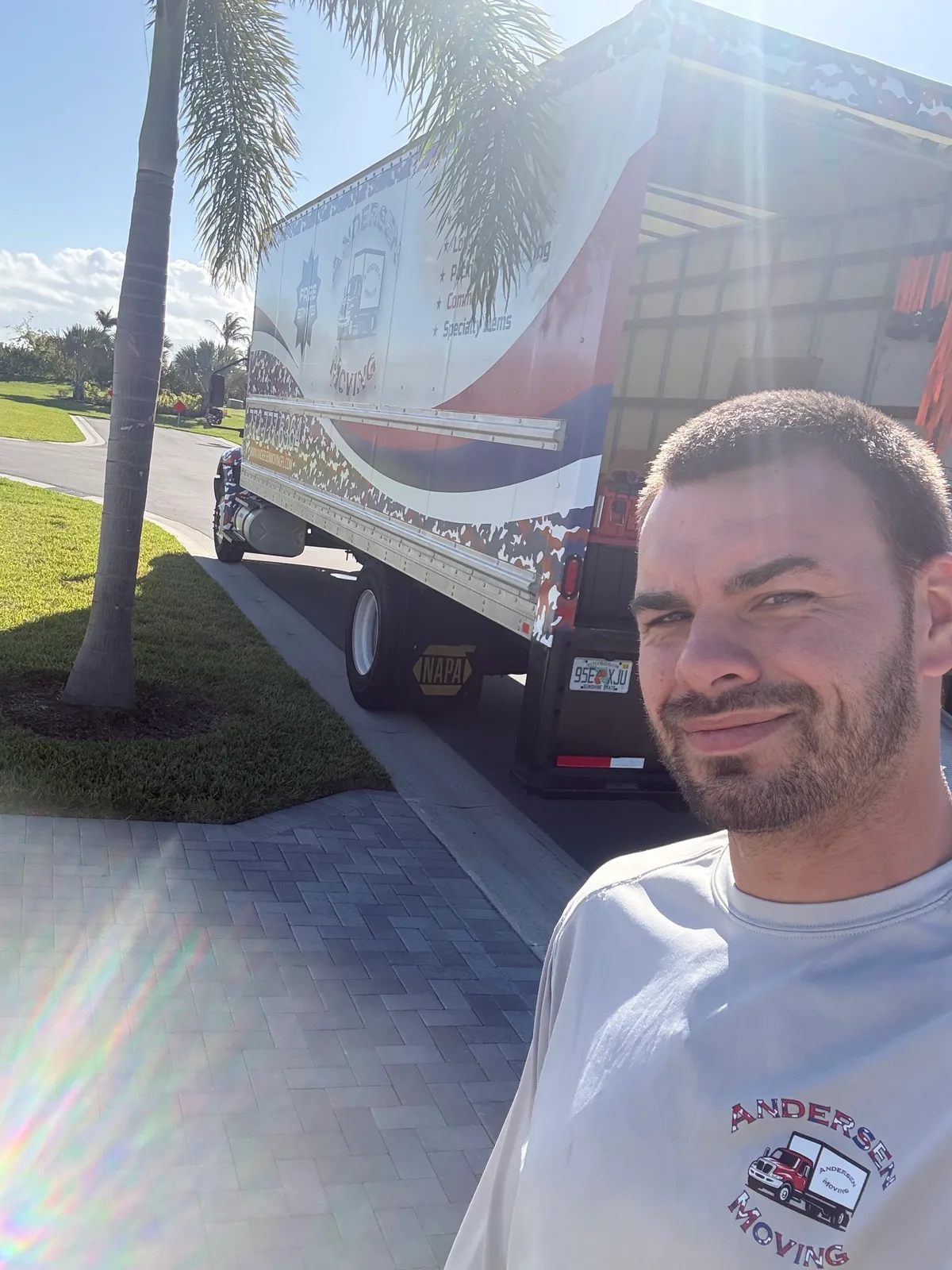 Ryan, owner of Andersen Moving, standing in front of his Andersen Moving box truck on the Treasure Coast